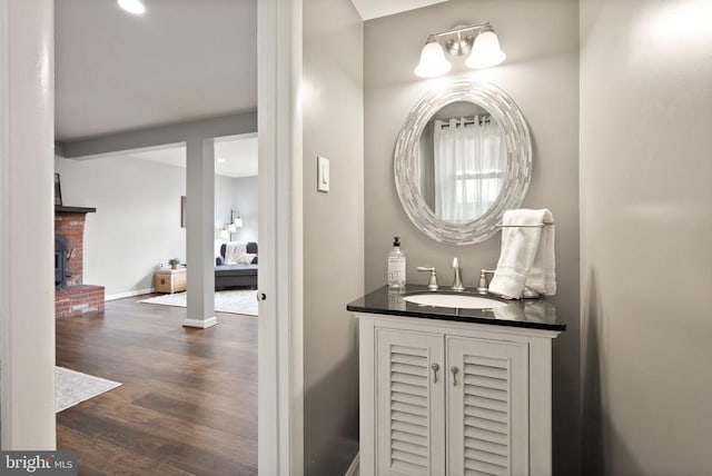  - bathroom with wood finished floors, vanity, recessed lighting, and baseboards