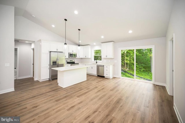 3149 Lewiston Rd, Bumpass, VA 23024 - kitchen with appliances with stainless steel finishes, white cabinets, a kitchen island, light countertops, and light wood-type flooring