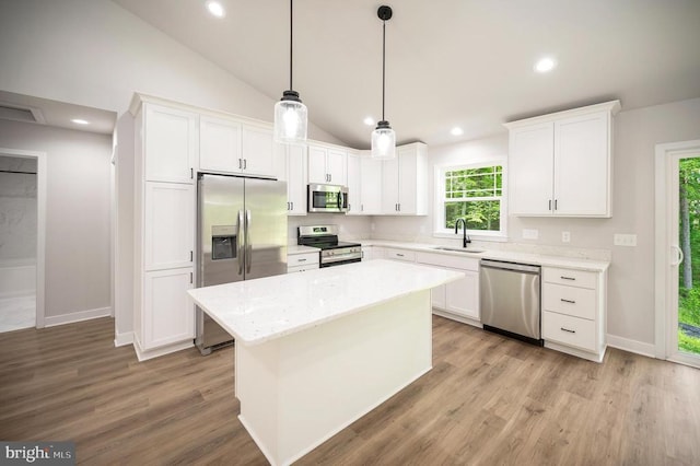 3149 Lewiston Rd, Bumpass, VA 23024 - kitchen featuring appliances with stainless steel finishes, a sink, light wood-style flooring, white cabinets, and lofted ceiling