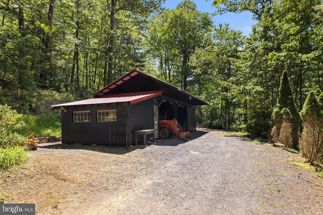 115 Oventop Mountain Ln, Sperryville, VA 22740 - view of front facade with metal roof, an outdoor structure, and a view of trees