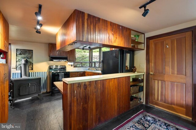 115 Oventop Mountain Ln, Sperryville, VA 22740 - kitchen with track lighting, black appliances, a wood stove, extractor fan, and open shelves