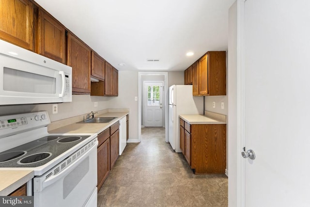 131 Wankoma Dr, Remington, VA 22734 - kitchen featuring white appliances, light countertops, brown cabinetry, recessed lighting, and light floors