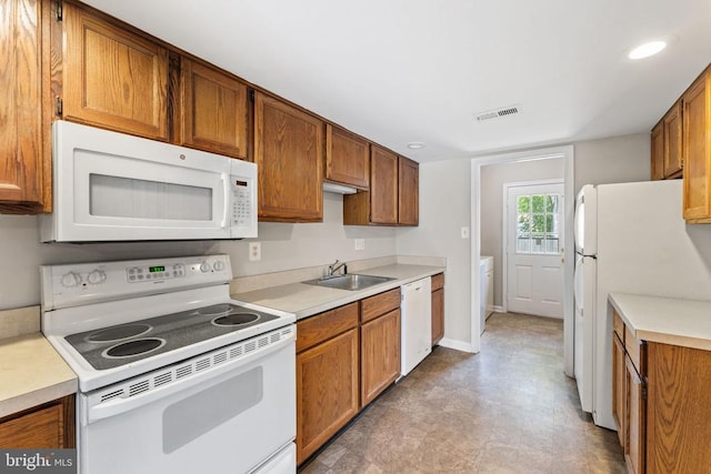 131 Wankoma Dr, Remington, VA 22734 - kitchen with white appliances, light countertops, brown cabinetry, and recessed lighting