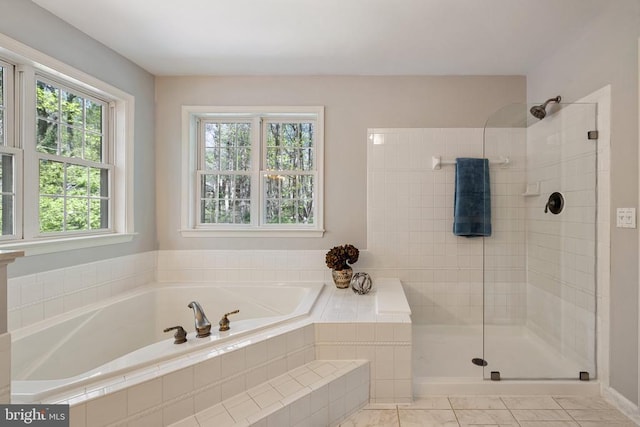  - full bathroom featuring a garden tub and a tile shower