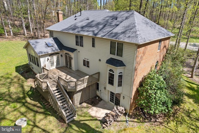  - rear view of property featuring french doors, a chimney, a wooden deck, a yard, and roof with shingles