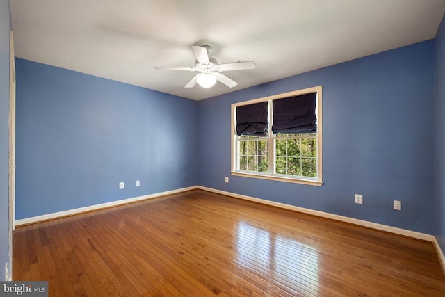  - empty room featuring baseboards, hardwood / wood-style floors, and ceiling fan