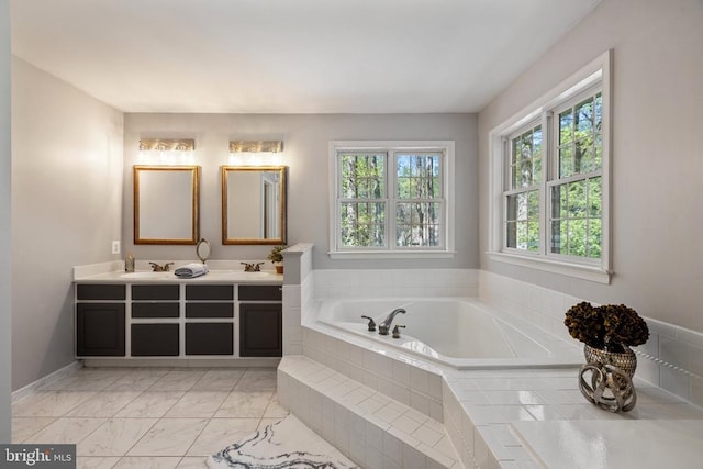  - bathroom with a garden tub, double vanity, and marble finish flooring