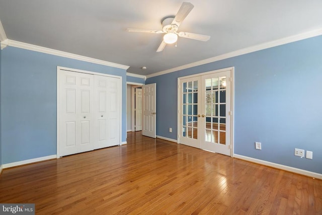  - unfurnished bedroom featuring french doors, baseboards, ornamental molding, wood finished floors, and ceiling fan