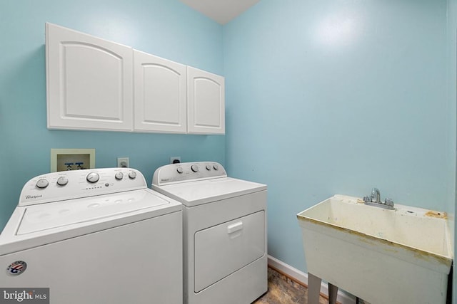  - washroom featuring cabinet space, independent washer and dryer, and wood finished floors