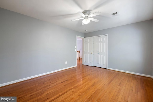  - unfurnished bedroom featuring baseboards, light wood-style flooring, a closet, and ceiling fan