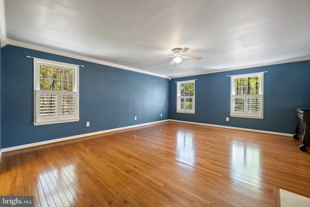  - empty room with ceiling fan, ornamental molding, wood-type flooring, and baseboards