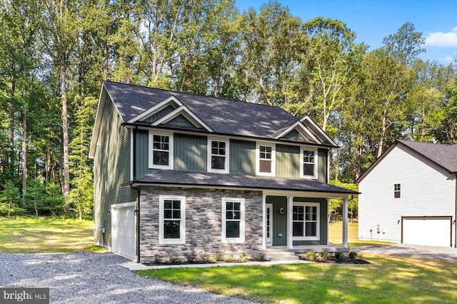 12521 Wilderness Park Dr, Spotsylvania, VA 22551 - craftsman-style home with a garage, driveway, stone siding, a front lawn, and a porch
