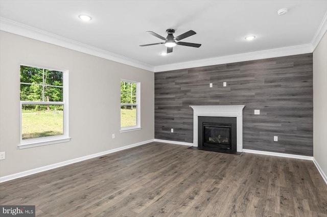 12521 Wilderness Park Dr, Spotsylvania, VA 22551 - unfurnished living room featuring an accent wall, ceiling fan, crown molding, a fireplace with flush hearth, and wood finished floors