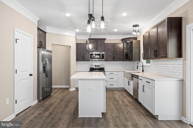 12521 Wilderness Park Dr, Spotsylvania, VA 22551 - kitchen featuring stainless steel appliances, dark brown cabinets, crown molding, light countertops, and tasteful backsplash