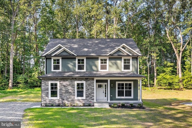 12521 Wilderness Park Dr, Spotsylvania, VA 22551 - view of front of home featuring a front lawn, covered porch, a shingled roof, and stone siding