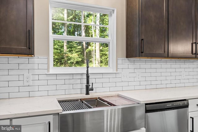 12521 Wilderness Park Dr, Spotsylvania, VA 22551 - kitchen with dishwasher, dark brown cabinets, light stone countertops, and backsplash