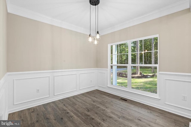 12521 Wilderness Park Dr, Spotsylvania, VA 22551 - unfurnished dining area with ornamental molding, a decorative wall, wainscoting, and dark wood finished floors