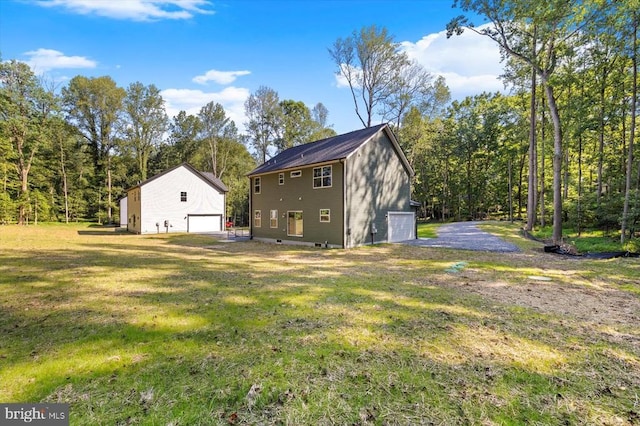 12521 Wilderness Park Dr, Spotsylvania, VA 22551 - view of property exterior with a detached garage, an outbuilding, and a yard