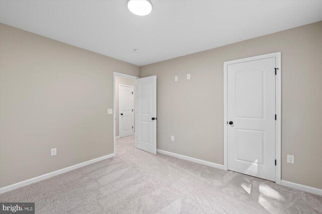 12521 Wilderness Park Dr, Spotsylvania, VA 22551 - unfurnished bedroom featuring baseboards and light carpet