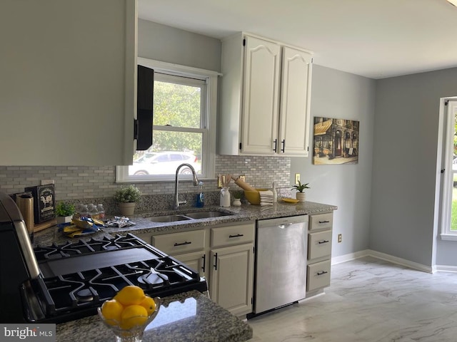 4209 Oakhill Rd, Fredericksburg, VA 22408 - kitchen featuring stainless steel dishwasher, light marble finish flooring, tasteful backsplash, and dark stone counters
