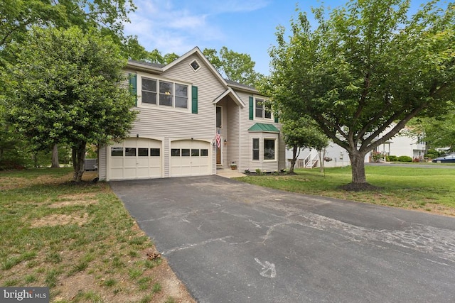 4209 Oakhill Rd, Fredericksburg, VA 22408 - traditional home with an attached garage, asphalt driveway, and a front lawn