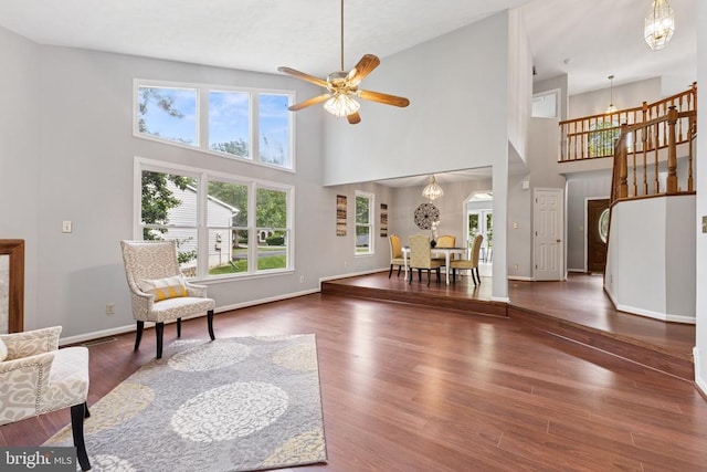 4209 Oakhill Rd, Fredericksburg, VA 22408 - living room with a chandelier, a high ceiling, wood finished floors, a ceiling fan, and stairs