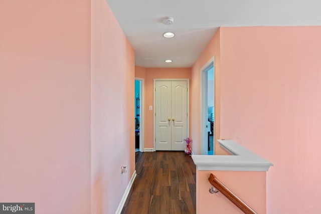 corridor featuring dark wood-style flooring, baseboards, and recessed lighting