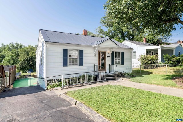 exterior space with a chimney, fence, and a lawn
