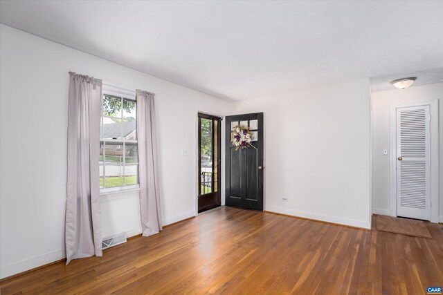 entryway featuring baseboards and wood finished floors