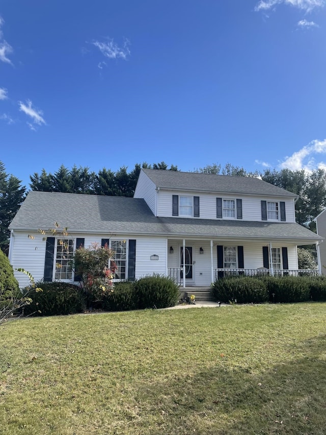 traditional-style house with a porch and a front lawn
