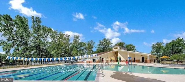 community pool featuring fence and a patio