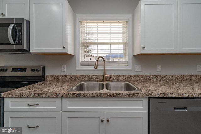 1087 Judy Ln, Stanley, VA 22851 - kitchen with appliances with stainless steel finishes, a sink, white cabinets, and dark countertops