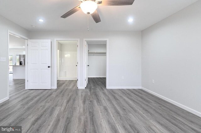 1087 Judy Ln, Stanley, VA 22851 - unfurnished bedroom with baseboards, stainless steel fridge with ice dispenser, wood finished floors, recessed lighting, and a walk in closet