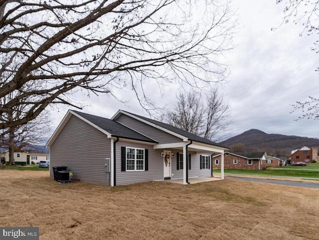 1087 Judy Ln, Stanley, VA 22851 - view of front facade featuring a mountain view, covered porch, a front yard, and cooling unit