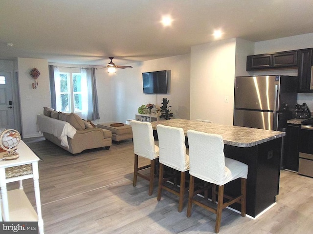 2414 Post Oak Dr, Culpeper, VA 22701 - kitchen with a kitchen bar, light wood-style floors, ceiling fan, a kitchen island, and light countertops