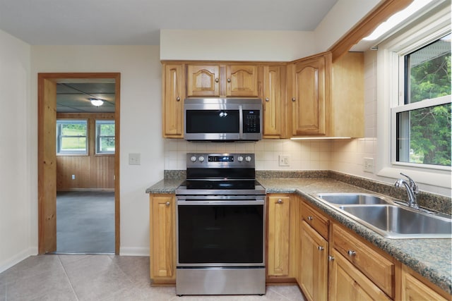3423 Smith Creek Rd, New Market, VA 22844 - kitchen featuring appliances with stainless steel finishes, a sink, backsplash, baseboards, and dark countertops