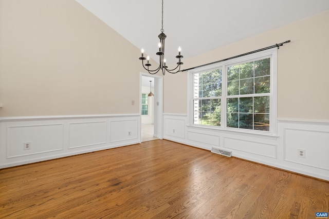 2777 Peppervine Ct, Charlottesville, VA 22911 - unfurnished dining area with a chandelier, wainscoting, wood finished floors, vaulted ceiling, and a decorative wall