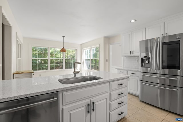 2777 Peppervine Ct, Charlottesville, VA 22911 - kitchen featuring stainless steel appliances, white cabinetry, light tile patterned flooring, light stone countertops, and recessed lighting