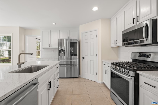 2777 Peppervine Ct, Charlottesville, VA 22911 - kitchen with stainless steel appliances, recessed lighting, light tile patterned flooring, white cabinetry, and healthy amount of natural light