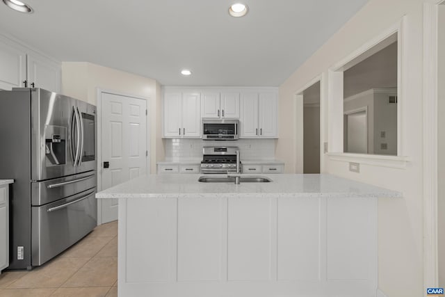 2777 Peppervine Ct, Charlottesville, VA 22911 - kitchen featuring appliances with stainless steel finishes, white cabinets, light tile patterned flooring, backsplash, and light stone countertops