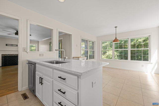 2777 Peppervine Ct, Charlottesville, VA 22911 - kitchen featuring light tile patterned floors, white cabinets, light stone countertops, a ceiling fan, and pendant lighting