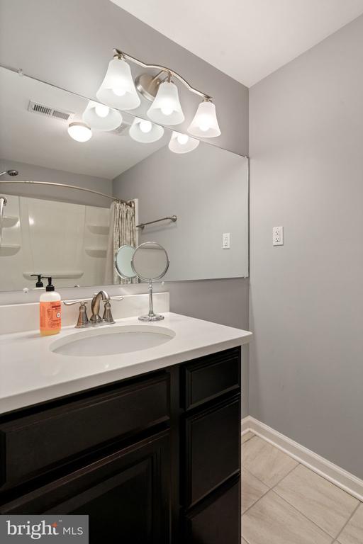 full bathroom with vanity, baseboards, tile patterned floors, and a shower with shower curtain
