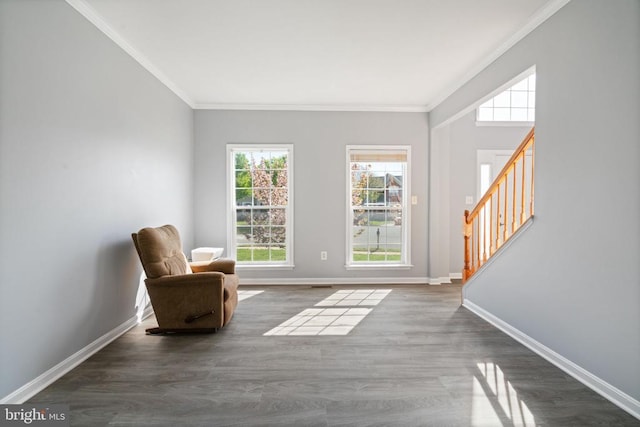 living area with stairway, ornamental molding, wood finished floors, and baseboards