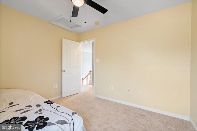 bedroom featuring carpet, baseboards, attic access, and ceiling fan