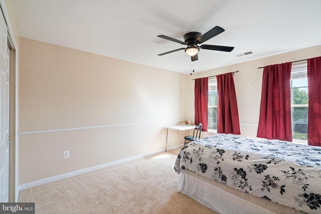 carpeted bedroom featuring baseboards and a ceiling fan