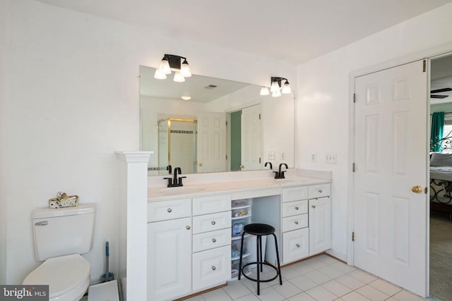 full bath featuring a stall shower, ensuite bathroom, double vanity, toilet, and tile patterned flooring