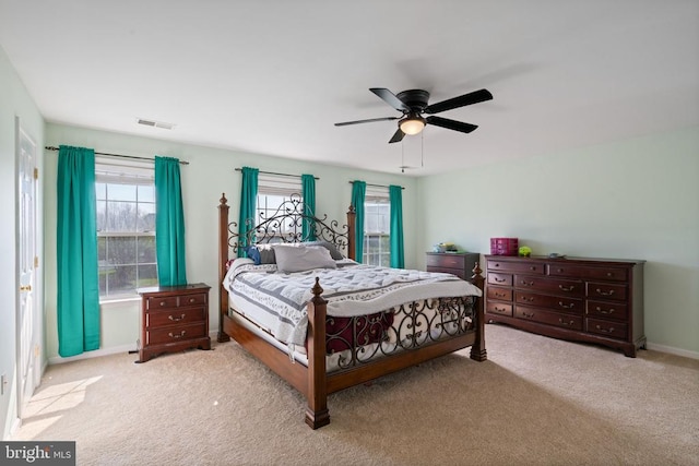 bedroom featuring light colored carpet, ceiling fan, and baseboards