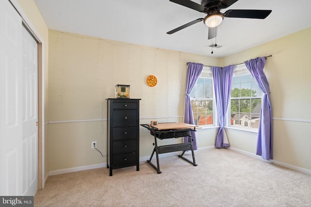 home office featuring light colored carpet, ceiling fan, and baseboards