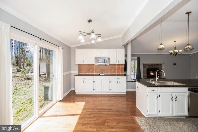 202 Yorktown Blvd, Locust Grove, VA 22508 - kitchen with a chandelier, appliances with stainless steel finishes, a sink, dark countertops, and white cabinetry