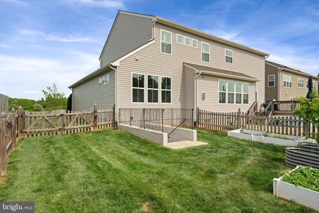 10430 Aspen Highlands Dr, Spotsylvania, VA 22553 - back of property with a vegetable garden and a gate
